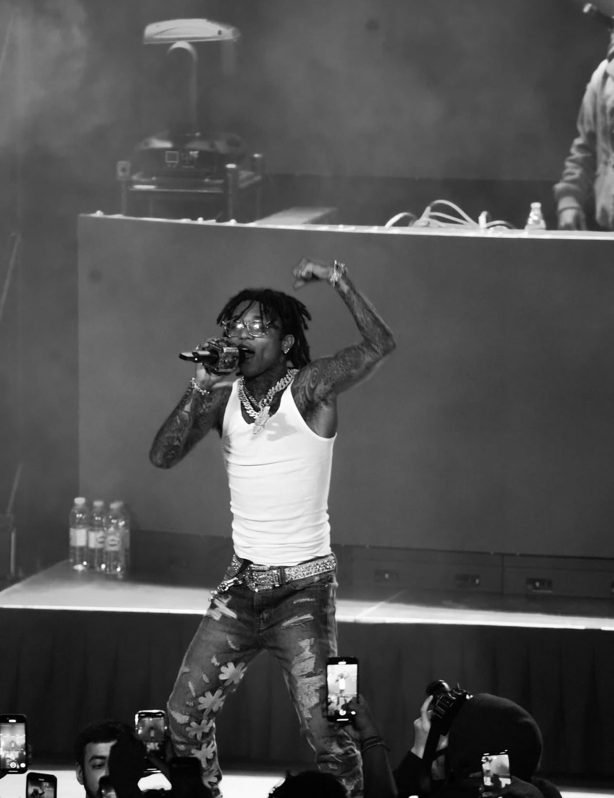 Live performer singing at centre stage in front of the audience