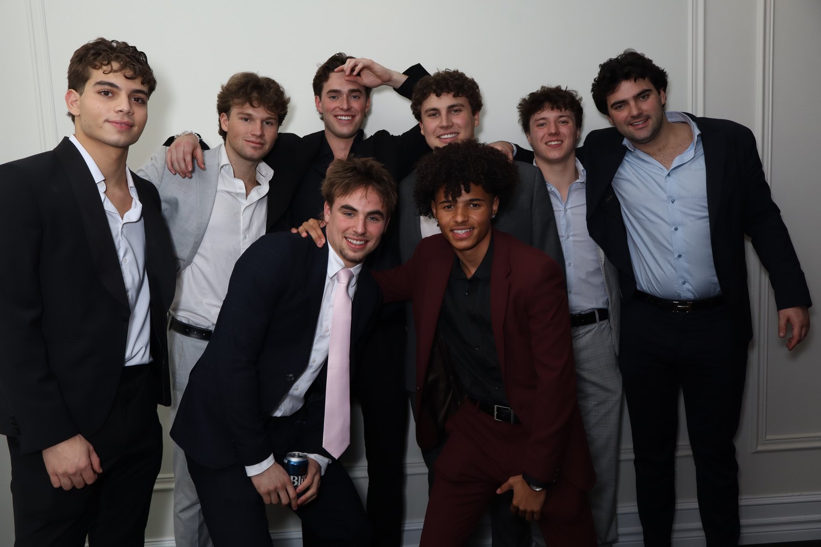 Guests in suits lined up for a group portrait