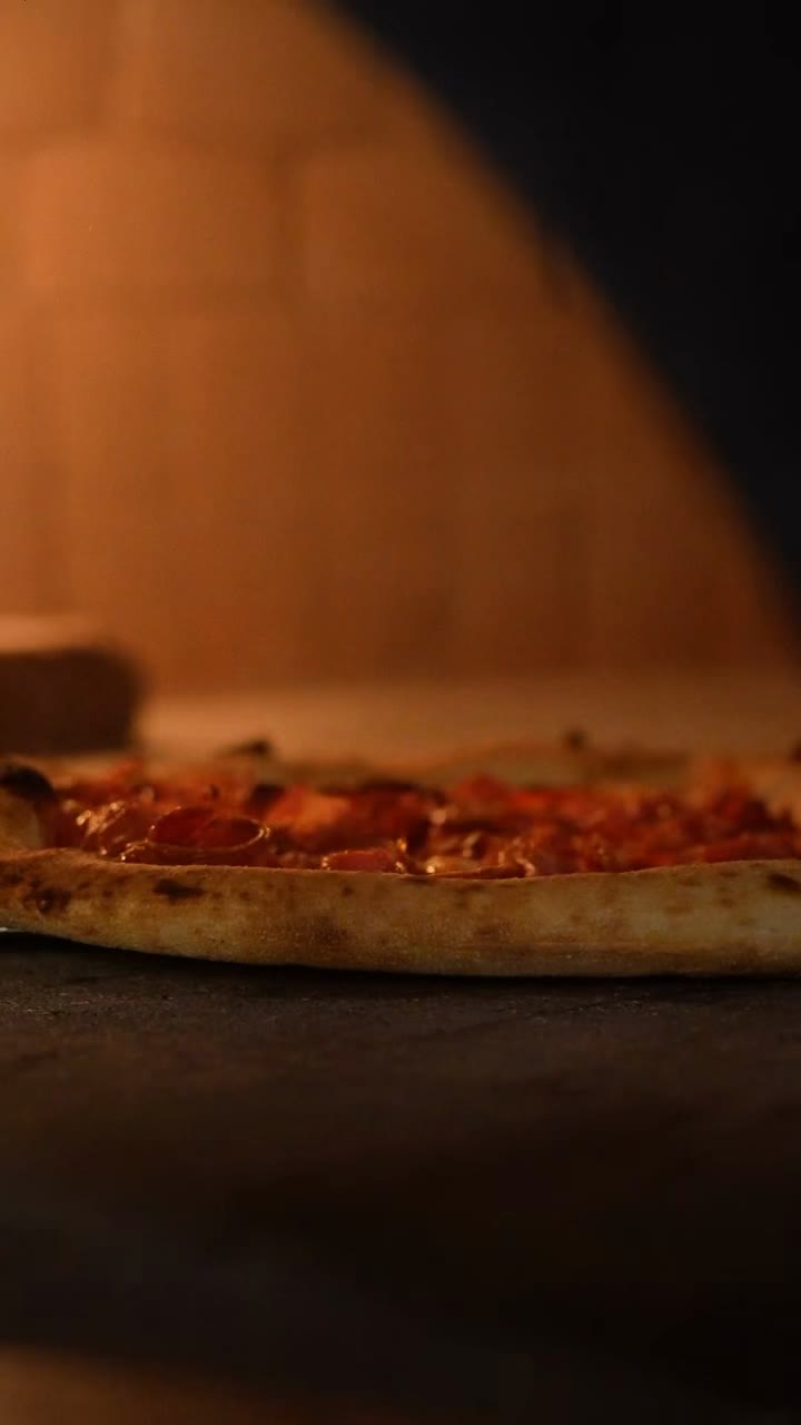 Close-up of pizza inside a wood-fired oven
